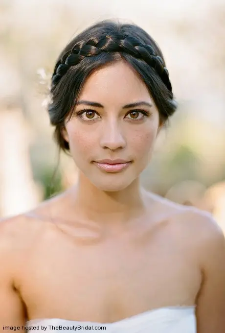 Crown braided bridal hairstyle with flowers