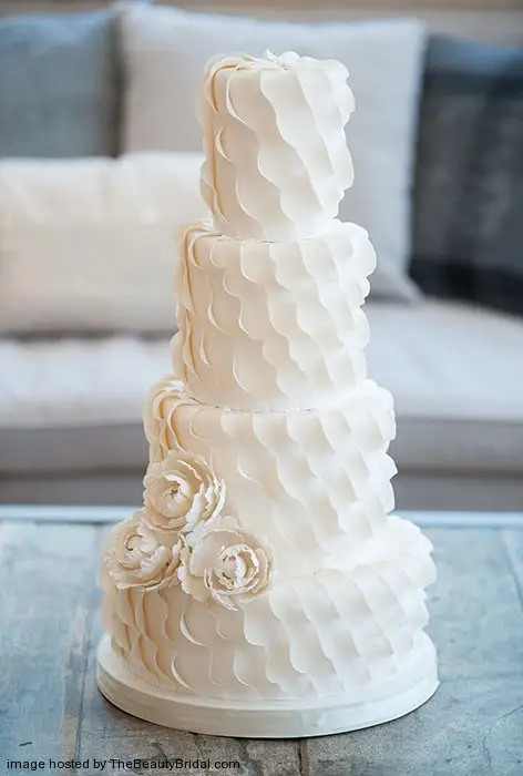 Diagonal ruffle wedding cake with peonies