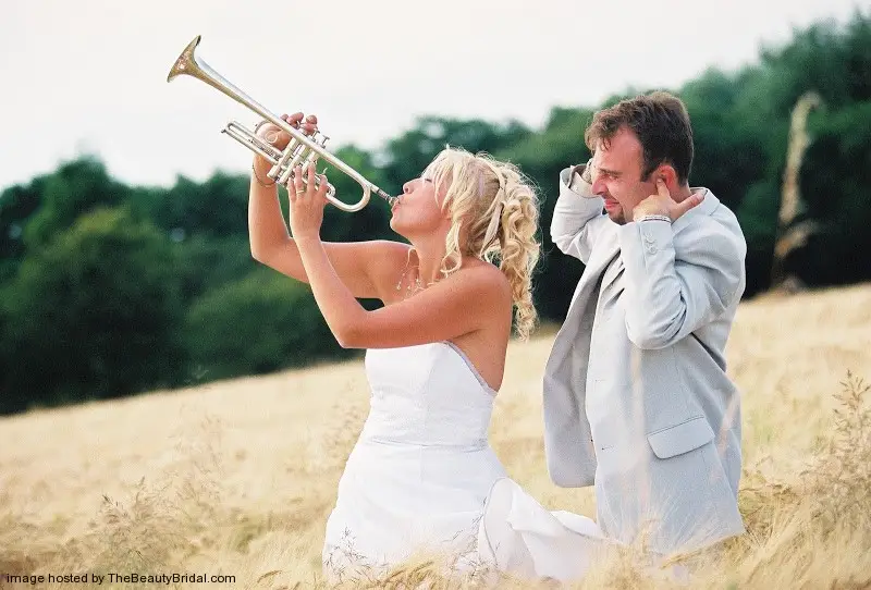 fun bride and groom in the field